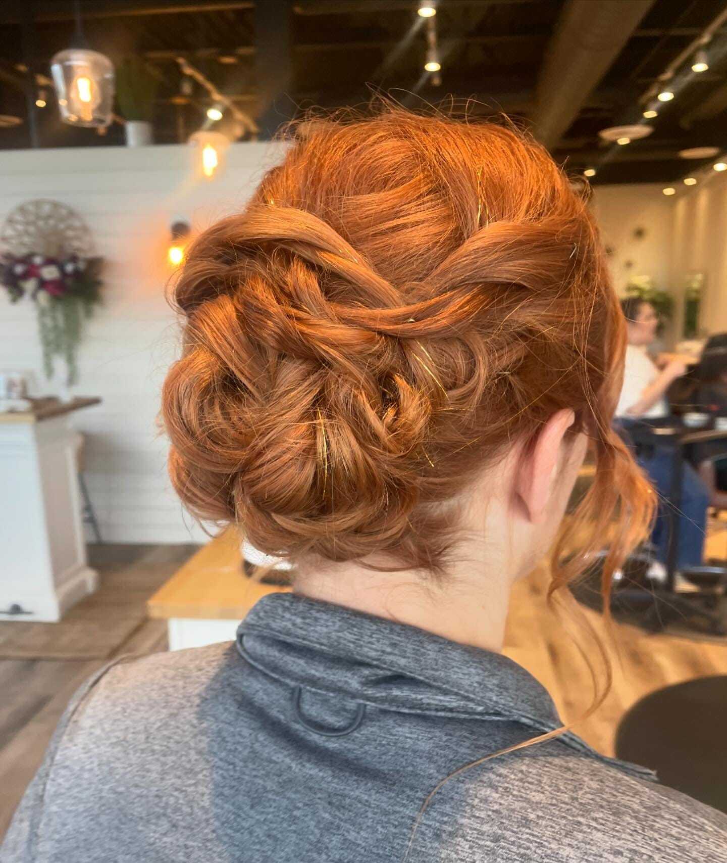 Intricate red braided updo hairstyle from the back.